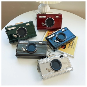 Detail showing various glossy patent leather camera-shaped bags with rhinestone accents