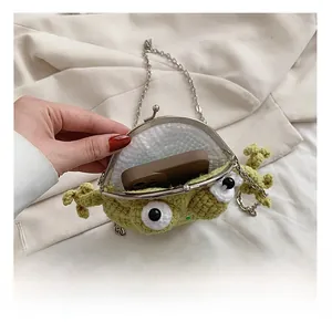 Detailed interior view of a green crochet monster bag showing space for a smartphone