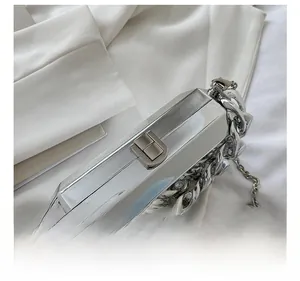Detail of metallic silver clutch with mirror finish, chunky chain and hardware clasp
