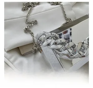 Macro shot of silver mirror metal bag showing high-quality hook and chunky chain detail