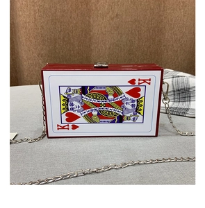 Detail of King of Hearts playing card clutch bag with red glossy frame and silver chain
