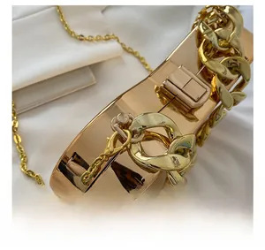 Detail showing the shiny gold mirror finish and durable metal lobster clasp of the handbag