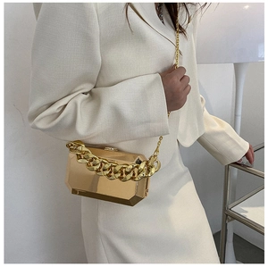 Close-up of golden geometric evening clutch bag with thick chunky chain handle