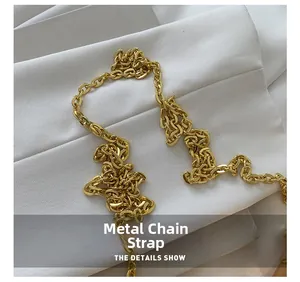 Detail of elegant gold metal chain shoulder strap for modern crossbody box handbags