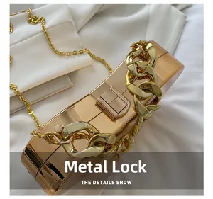 Detailed view of the rose gold metallic clutch bag featuring a square hardware lock
