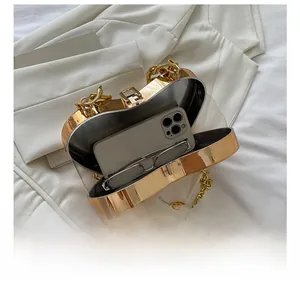 Interior view of gold heart chain bag showing capacity for a smartphone and glasses