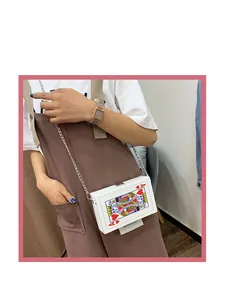 Detail of playing card shaped crossbody bag with Ace of Hearts print and metal chain