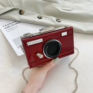 Retro camera-shaped crossbody bag in burgundy patent leather with silver chain strap