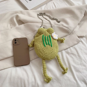 Green handmade crochet frog crossbody bag with silver chain strap and flower detail