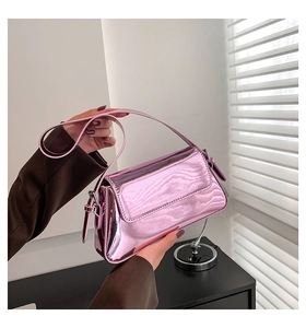 Detail of pink metallic mirror finish underarm bag with slim shoulder strap and shiny texture