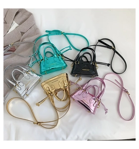 Detailed view of five mini patent leather crossbody bags in metallic fashion colors
