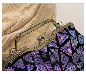 Macro shot of colorful iridescent sequins and vintage golden clasp on shell-shaped bag