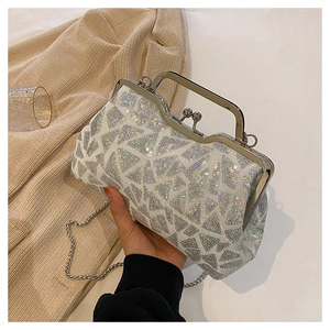 Close-up of silver sequin evening bag with metallic frame and colorful reflections