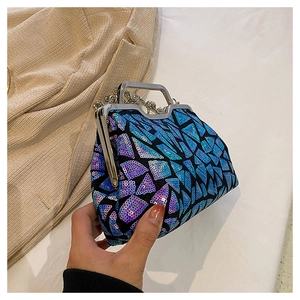 Close-up of sparkling sequin evening bag with metallic handle and luxury chain strap