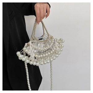 Detail of beaded evening bag featuring white pearls and a silver metallic inner pouch