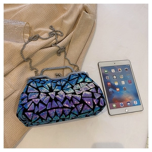 Macro shot of colorful geometric sequin evening bag with silver chain and metal clasp