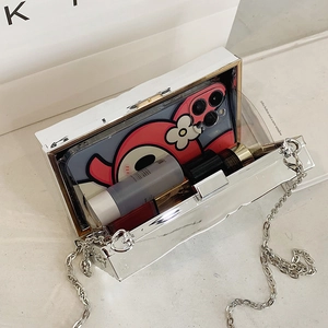 Silver mirror mini bag with metal chain showing internal storage for phone and lipstick
