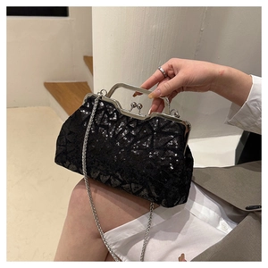 Detail of black sequin evening bag featuring vintage silver clasp and metallic chain