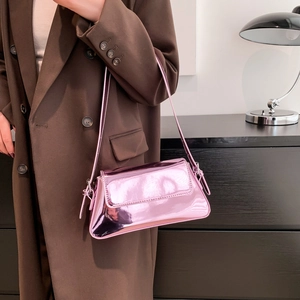 Pink glossy metallic baguette shoulder bag with a mirror finish and modern slim design