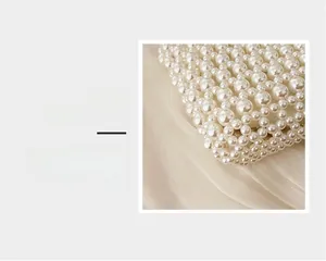Close-up of white pearl woven bag showing handmade beaded texture and glossy finish