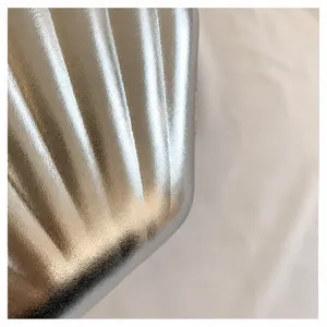Detailed close-up showing silver striped shell texture and metallic finish on the bag