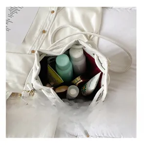 Top view showing the large capacity and red lining of the white drawstring bucket bag
