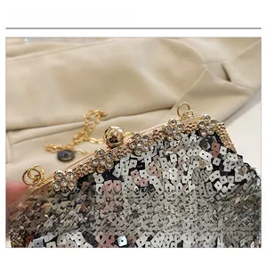 Close-up of luxury evening bag with silver sequins and gold floral rhinestone clasp
