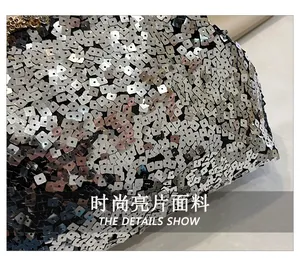 Macro detail of silver sequins fabric with rhinestone clasp for evening clutch bag