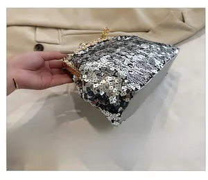 Detailed side view showing silver sequins and smooth faux leather texture on the evening bag