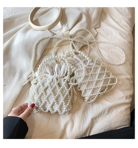 Detailed macro view of handmade white pearl woven bag with inner drawstring pouch