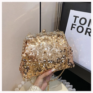 Detailed view of luxury gold sequin evening clutch with crystal floral metal frame