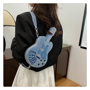 Detail of guitar-shaped denim crossbody bag with white stitching and brand text