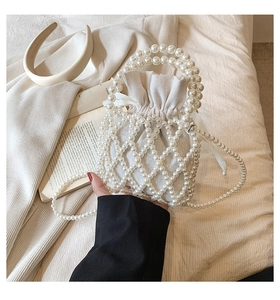 Detailed macro view of woven faux pearl lattice and beige drawstring inner pouch