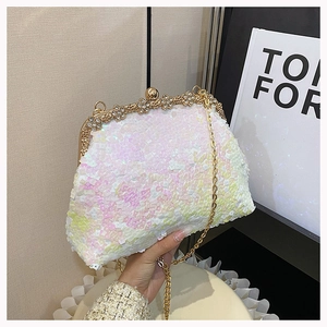Detail of sequined evening bag with floral gold metal frame and spherical clasp