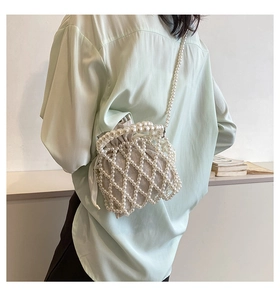 Detailed close-up of handmade pearl woven handbag featuring elegant hollow mesh design
