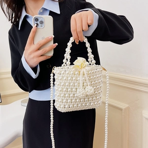White faux pearl woven handbag with satin drawstring inner bag and dual chain straps