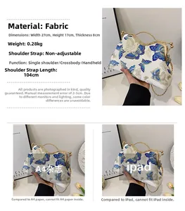 Detail of white fabric clutch with blue butterfly print and metal chain strap dimensions