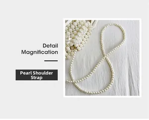 Detail magnification of the elegant pearl shoulder strap and woven pearl texture