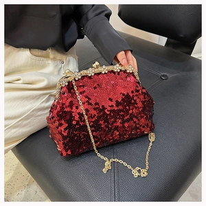 Detail of red sequin evening bag with gold crystal clasp and metal chain strap