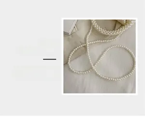 Detail magnification of the white pearlescent woven strap for the stylish handbag