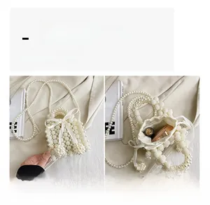 Detail showing the internal capacity and elegant white pearl beaded design of this mini bag