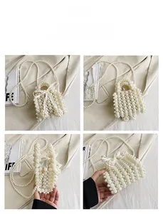 Detail of a handmade pearl woven handbag with a satin bow and crossbody chain strap