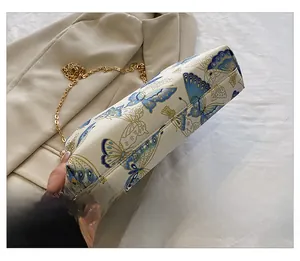 Close-up of the stitching craftsmanship on the bottom of a butterfly print handbag