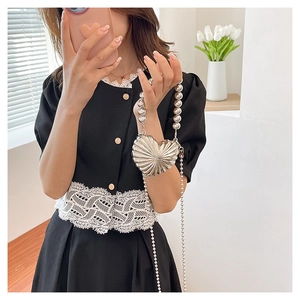 Silver heart-shaped metallic mini bag with textured surface and pearl handle