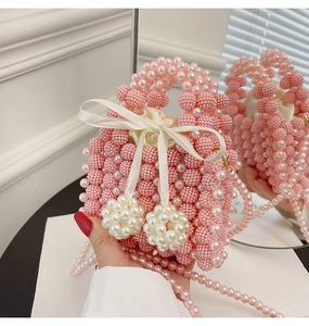 Detail of light pink pearl beaded handbag with satin bow and drawstring lining