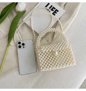 Detailed view of pearl woven handbag featuring round handle and detachable chain strap