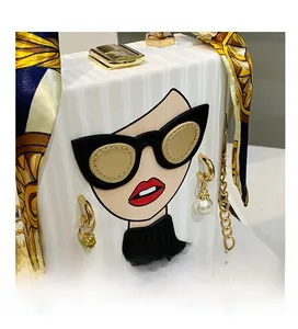 Detail of white box bag featuring a 3D fashion portrait with pearl earrings and silk scarf