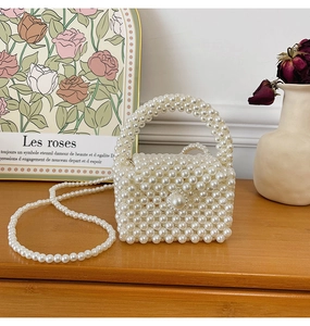 Detailed view of handmade white pearl woven handbag with elegant top handle and strap