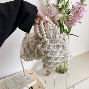 Elegant pearl bucket bag with linen drawstring pouch and long pearl chain strap