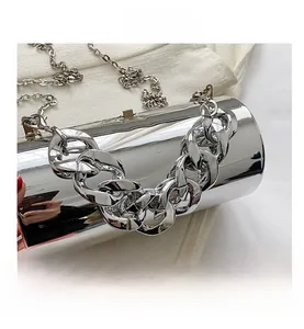 Macro shot of silver cylindrical acrylic handbag with chunky chain and mirror finish